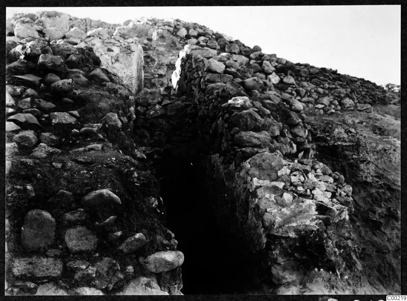 Rubble stone walls with a narrow dark opening between them at the theatre at Soli