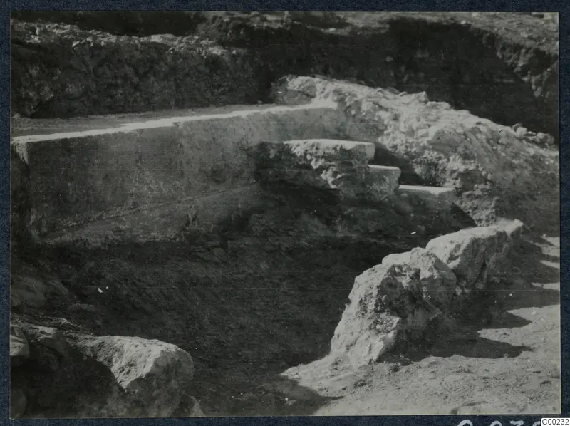 Excavated stone steps beside a large dressed block at the theatre at Soli
