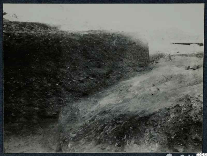 Excavated soil section and sloping trench at the theatre at Soli, with a hillside in the background