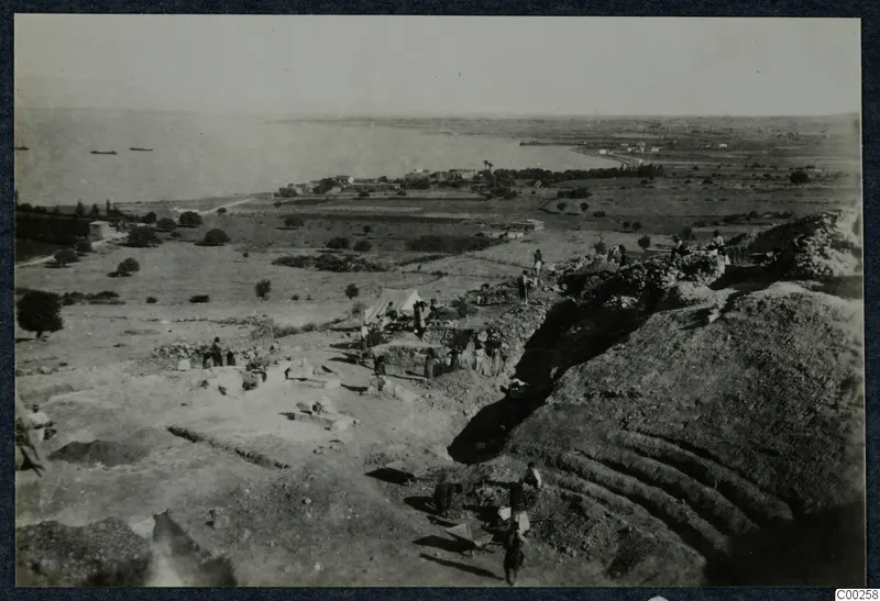 Excavation of the theatre at Soli, with workers, a tent and the sea beyond