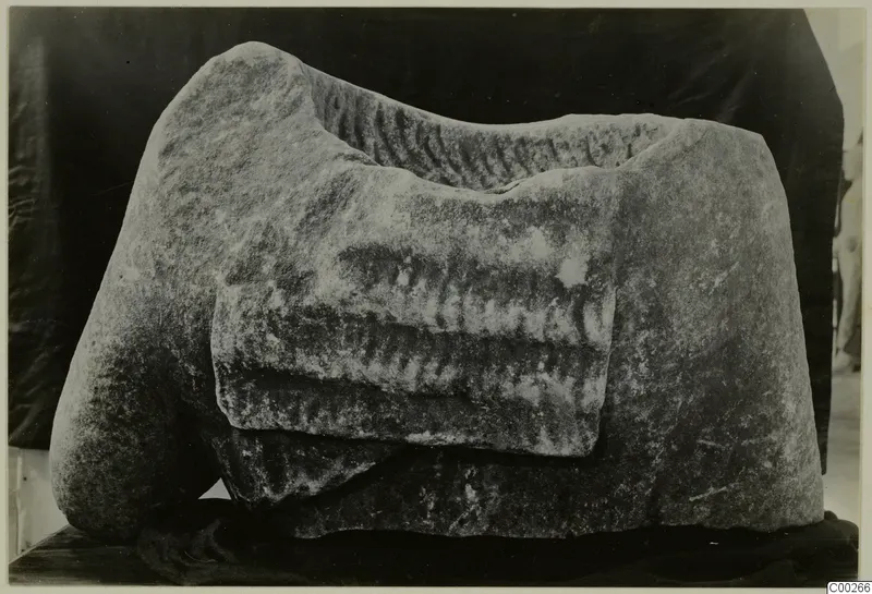 Back of a marble kore sculpture fragment from Galini, with long hair carved in parallel rows