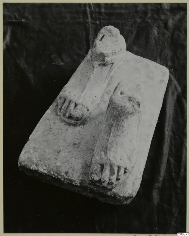 Limestone sculpture base with two carved feet from Vouni