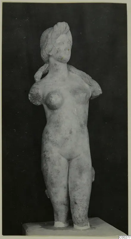 Marble statue of a female nude, probably representing Aphrodite, with the arms broken off, standing on a plinth