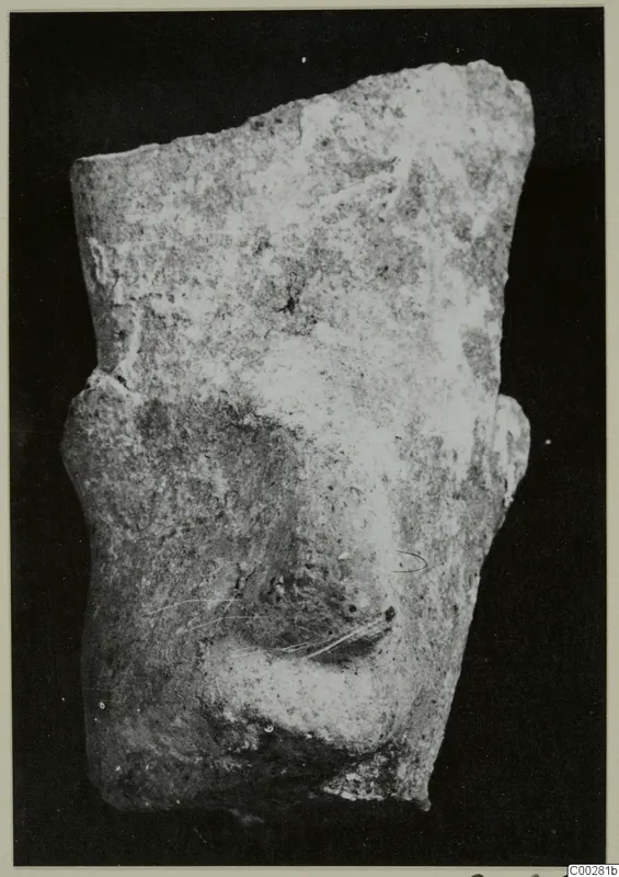 Fragment of a modelled terracotta figure showing a nose and lips, broken along the top and sides