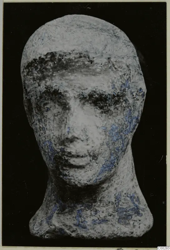 Terracotta Minor Plastic 2, a head figurine with a neck, seen from the front against a black background