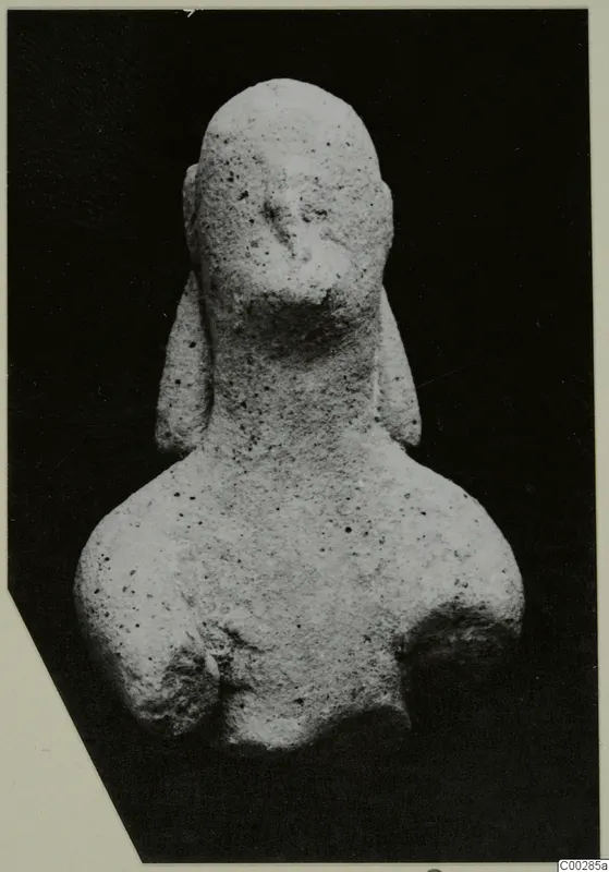 Terracotta figurine of a head and shoulders, with hair falling in long locks beside the neck