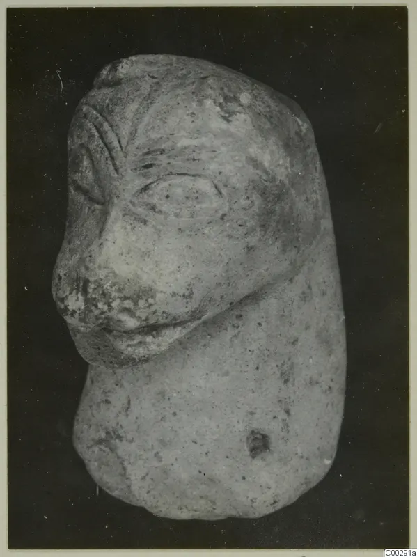 Terracotta figurine of a head with a projecting nose and mouth on a short rounded body, from Soli.