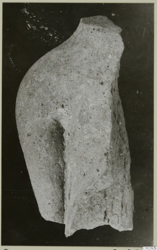 Fragment of a small terracotta figurine from Soli, showing a rounded shoulder or arm and a broken edge
