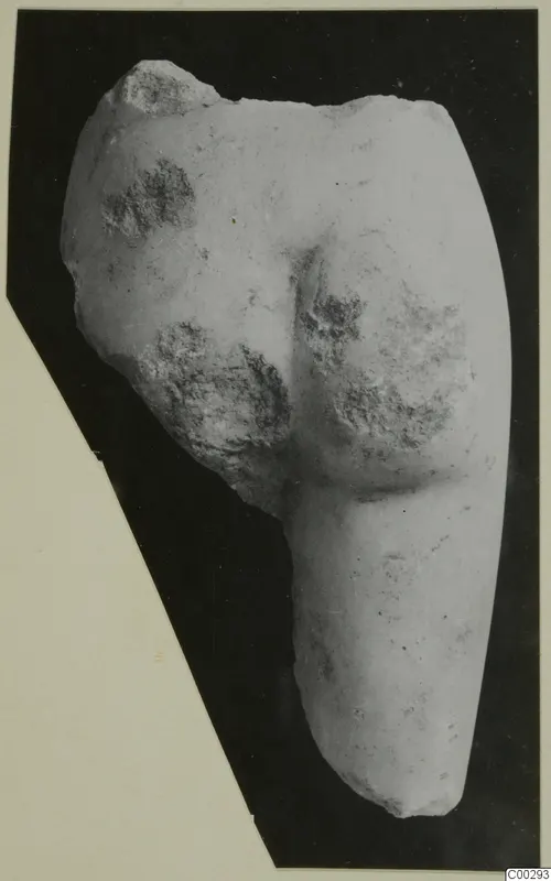 Marble sculpture fragment seen from behind, showing rounded buttocks and the upper parts of the legs