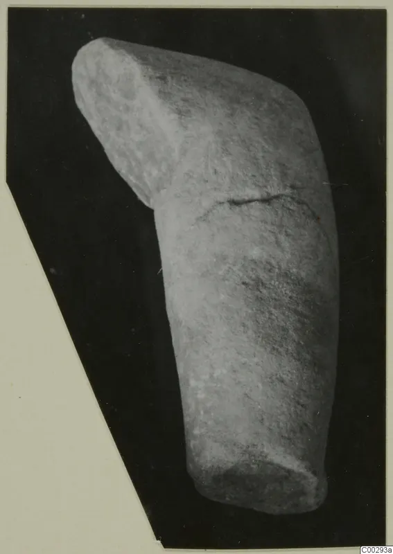 Marble sculpture fragment, a rounded stone piece with an angled upper block and a crack across its middle