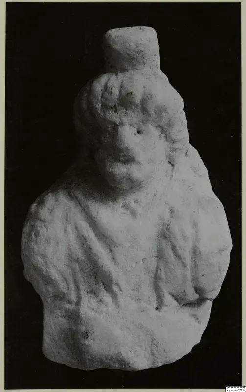 Marble sculpture of a head and upper body with wavy hair and draped shoulders, against a dark background