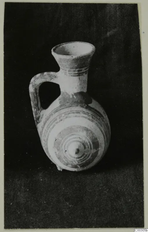Pottery Bichrome II juglet with a flared neck, one loop handle and painted concentric rings on the body