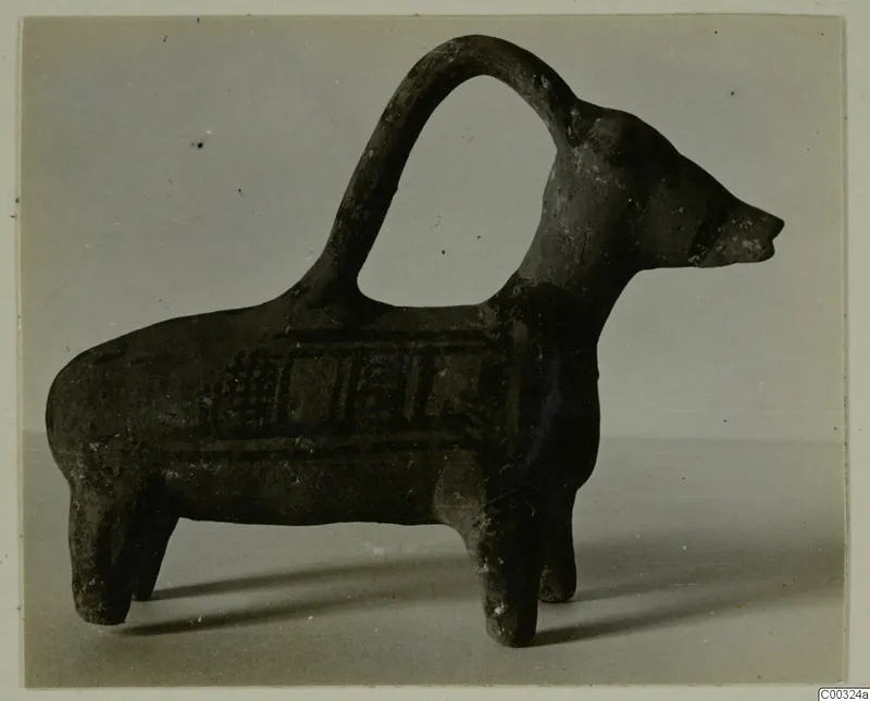 Pottery vessel shaped as a four-legged animal with an arched strap handle over its back, from Lapithos.