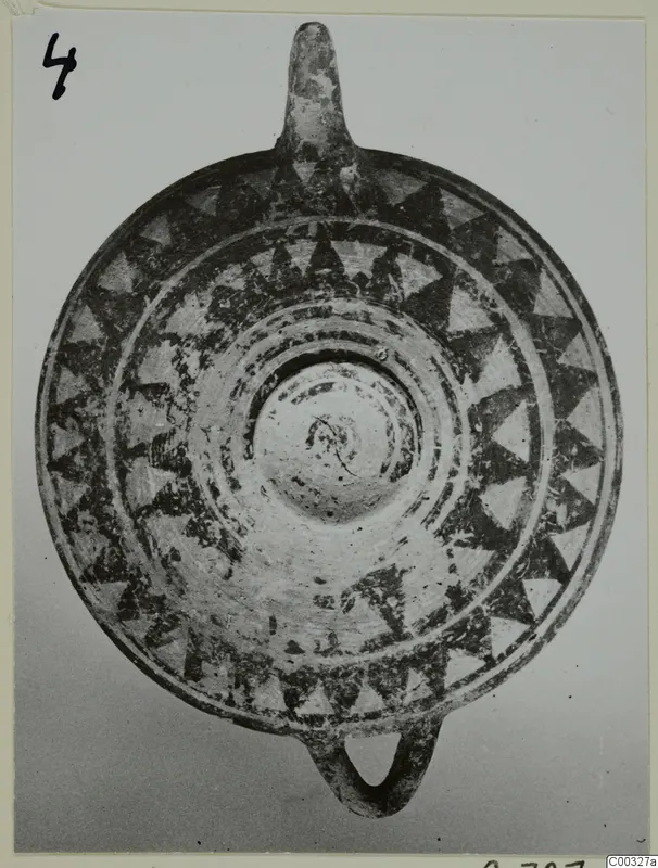 Round painted clay object with dark triangle bands, seen from above, from the Kastros tombs at Lapithos