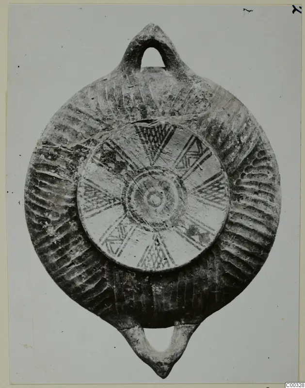 Black Slip Bichrome oil lamp from the Kastros tombs at Lapithos, with a loop handle at top and bottom