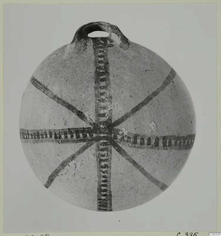 White Painted I bowl (L.420.27), a round vessel with a loop handle and dark painted bands radiating from the centre of the body