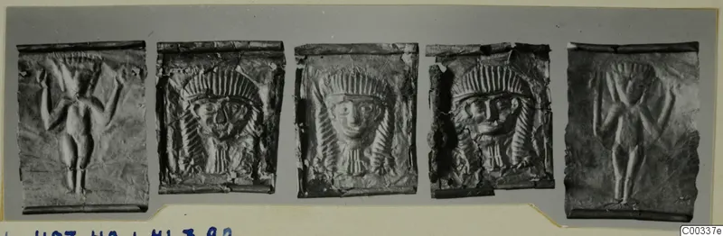 Five embossed metal plaques in a row: two with standing figures with raised arms, three with frontal faces wearing headdresses.