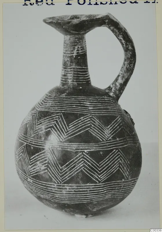 Red Polished II jug from Lapithos with white-filled incised zigzag and horizontal bands on a dark body