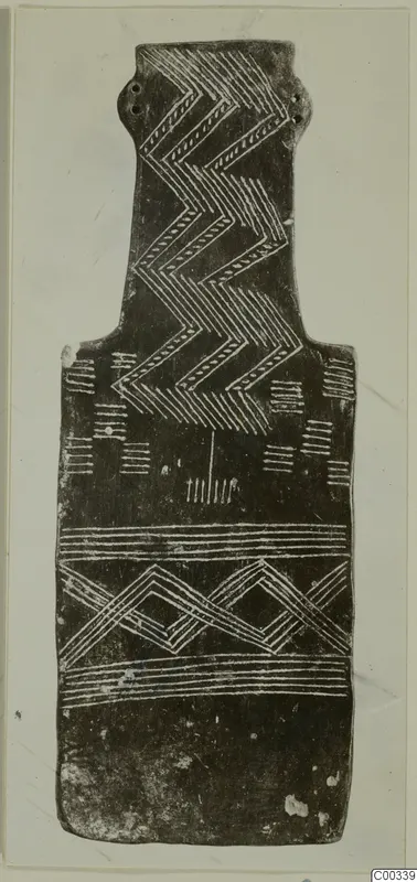 Plank-shaped idol from Lapithos, decorated with incised zigzag and banded patterns.