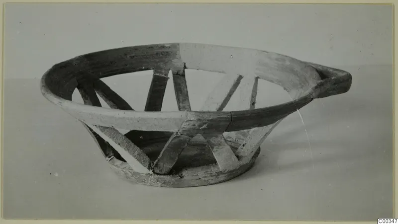 Pottery White Painted II from Lapithos: a shallow vessel with openwork struts between rim and foot and a horizontal handle