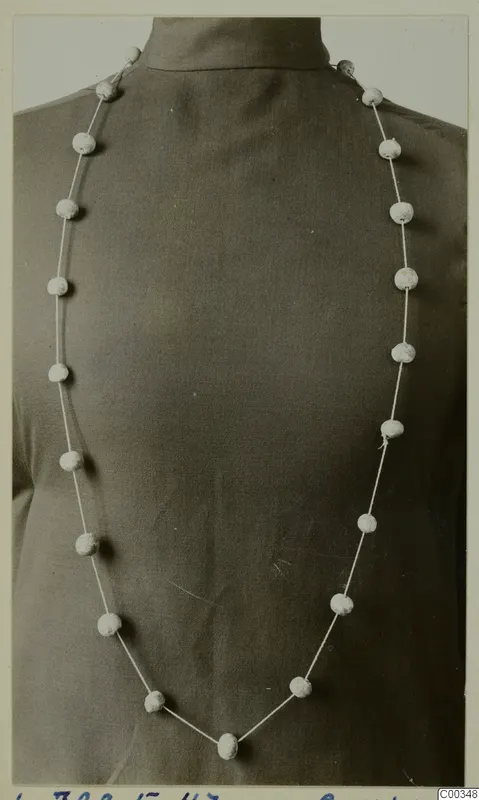 Necklace of pale round beads on a thin cord, from the Vrysi tou Barba tombs at Lapithos