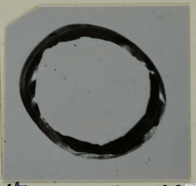 Gold ring, one of the find group of gold rings, pins and pendants, shown against a grey background