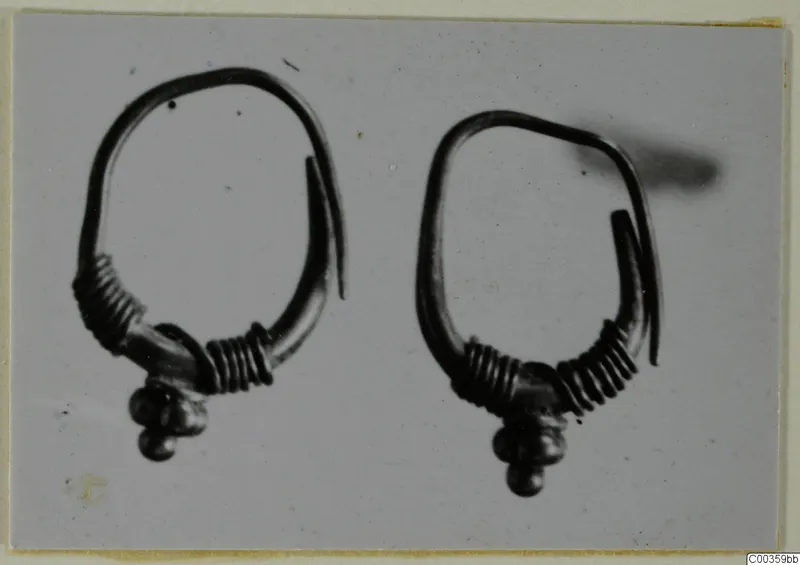 Two gold loop rings with coiled wire and clusters of small round beads hanging from the base, shown side by side.