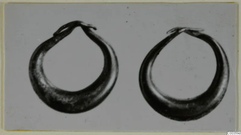 Two gold hoop rings from Lapithos shown side by side against a plain background
