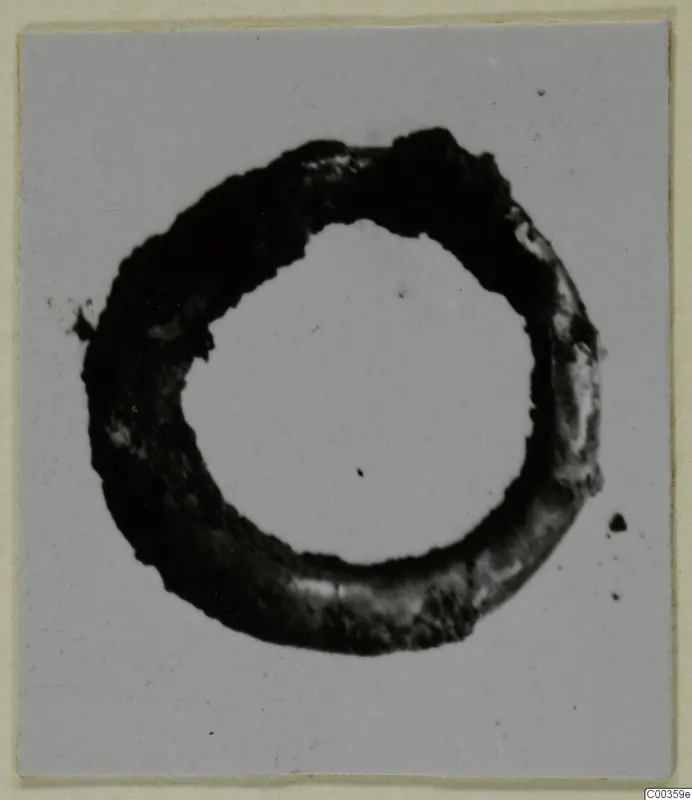 Gold ring from the Kastros tombs at Lapithos, photographed alone on a light background