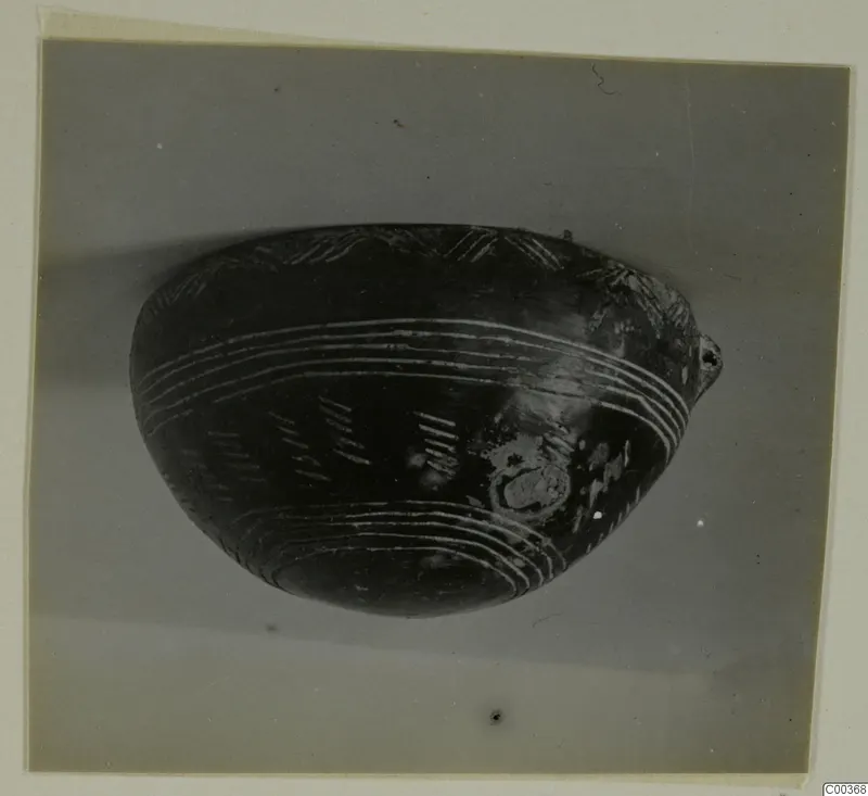 Black Polished bowl with pale grooved bands and hatched marks on its side