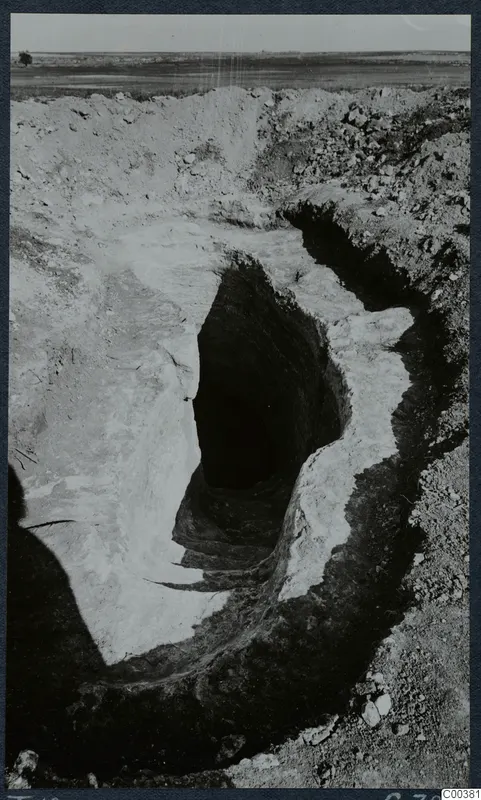 Dromos leading down to the entrance of Tomb 12 at Milia, cut into pale earth