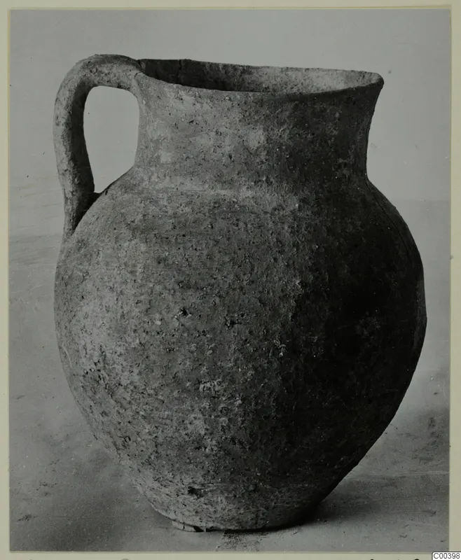 Coarse ware jug from the Kastros tombs at Lapithos, seen from the side against a plain background