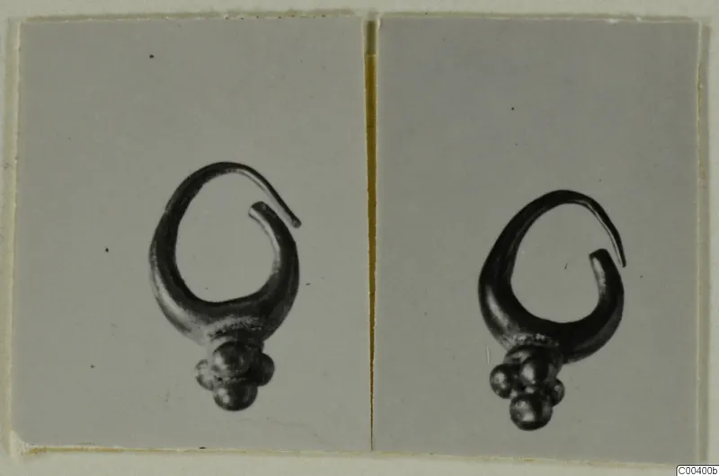 Two photographs of the same gold earring with an open loop and a cluster of small round beads at its base.