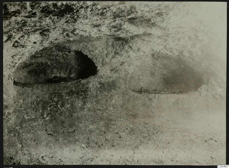 Tomb 309 at Lapithos: rock-cut tomb chamber during excavation, with bone remains on the floor at the right
