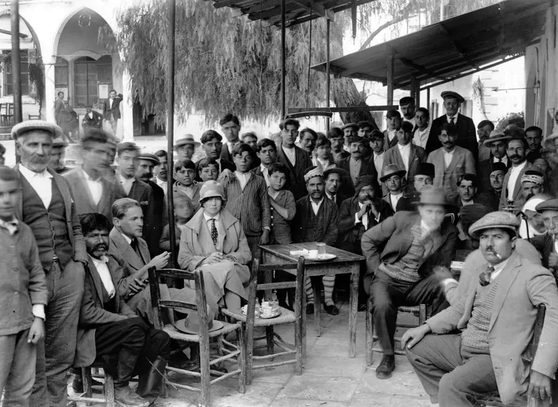 Crowd of men and a seated woman at a kafeneion café terrace in Kalavasos