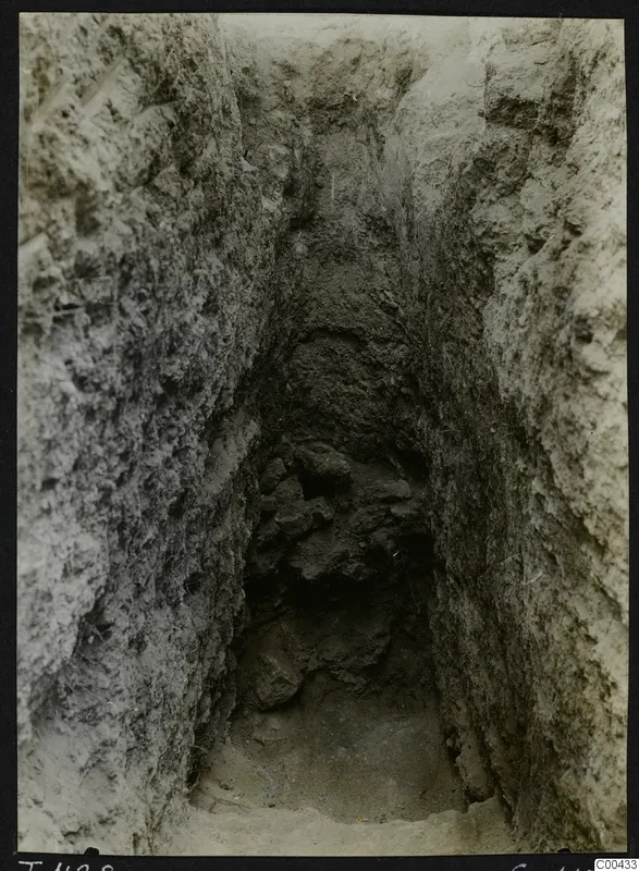 Tomb 428 at Lapithos during excavation: a narrow cut with stones and rubble at its far end