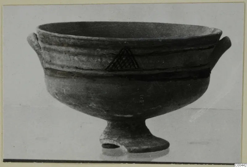 Footed bowl with two small horizontal handles, dark painted bands and a hatched triangle, from the Kastros tombs at Lapithos