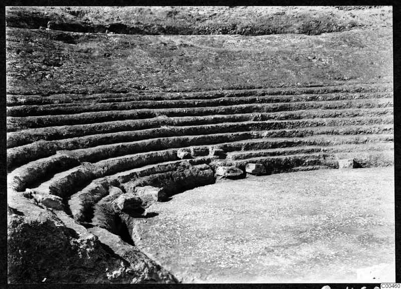 Curved tiers of stone steps at the theatre at Soli, with a flat paved area in the foreground
