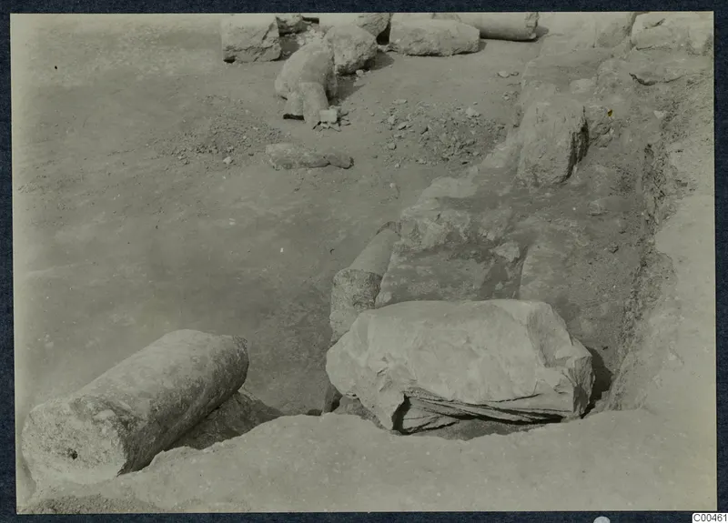 Excavation at Soli theatre with fallen stone column drums and blocks lying in the dug ground.