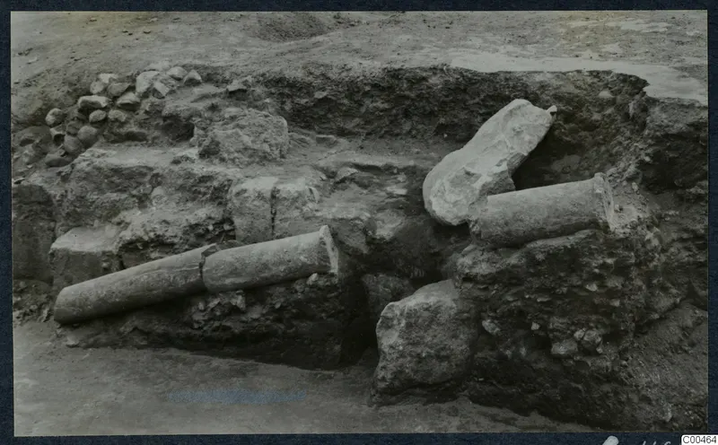 Excavated trench at Soli with two column drums lying on stone walls and a broken stone block beside them