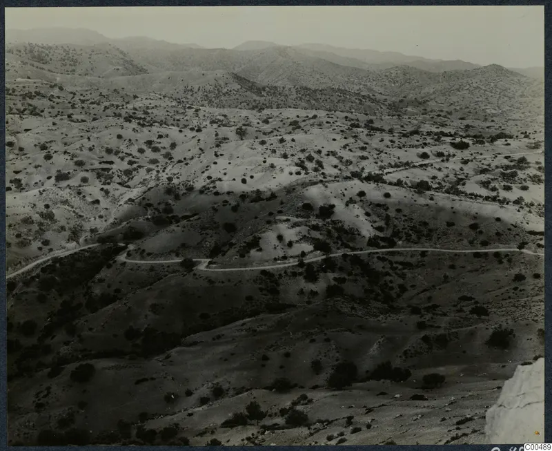 Rolling scrubland hills with a winding road, viewed from a height near Vouni