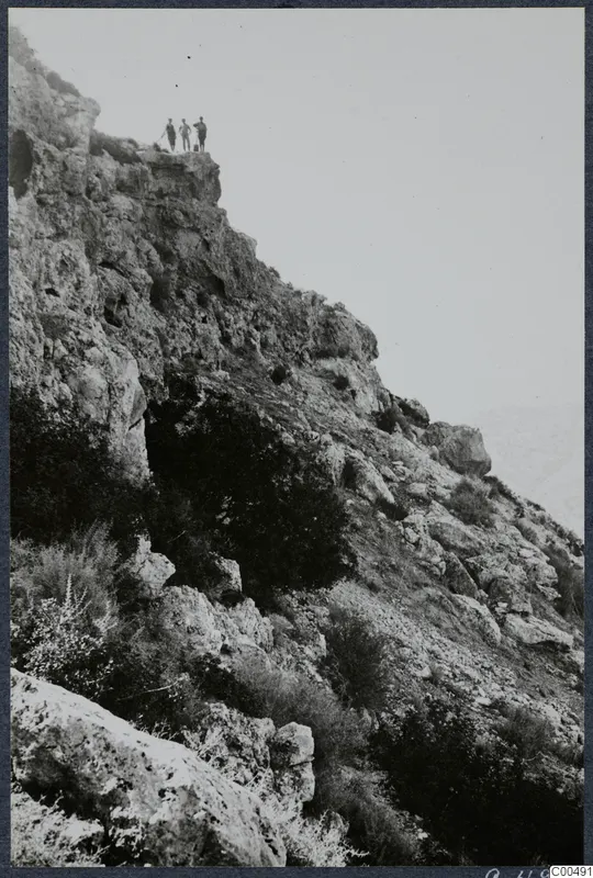 Steep rocky hillside at Vouni with three people standing on the ridge above