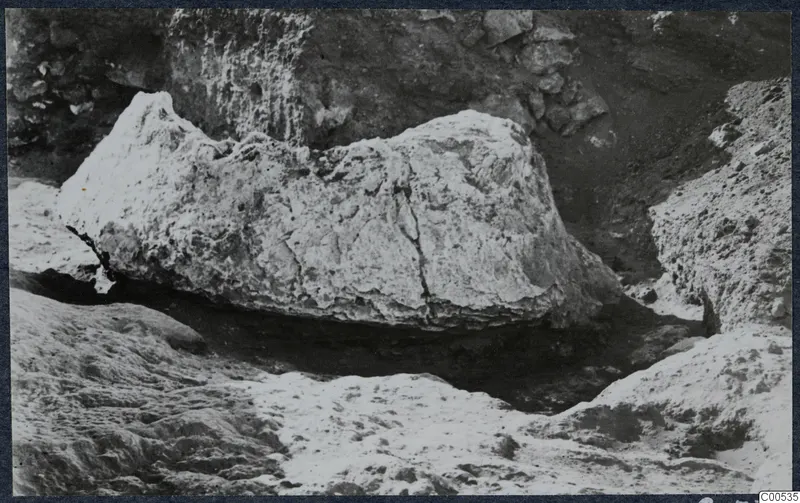 Large pale stone block lying in an excavated hollow at the palace at Vouni