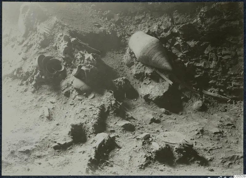 Pottery vessels and stones lying in situ in an excavated area at Vouni Palace