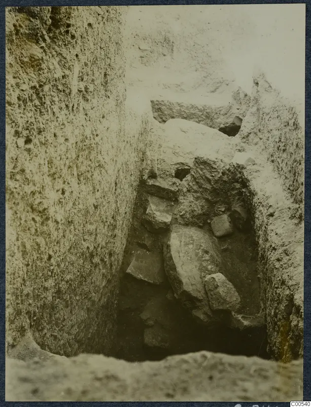 Narrow excavation trench at Vouni with loose stones lying in the cut