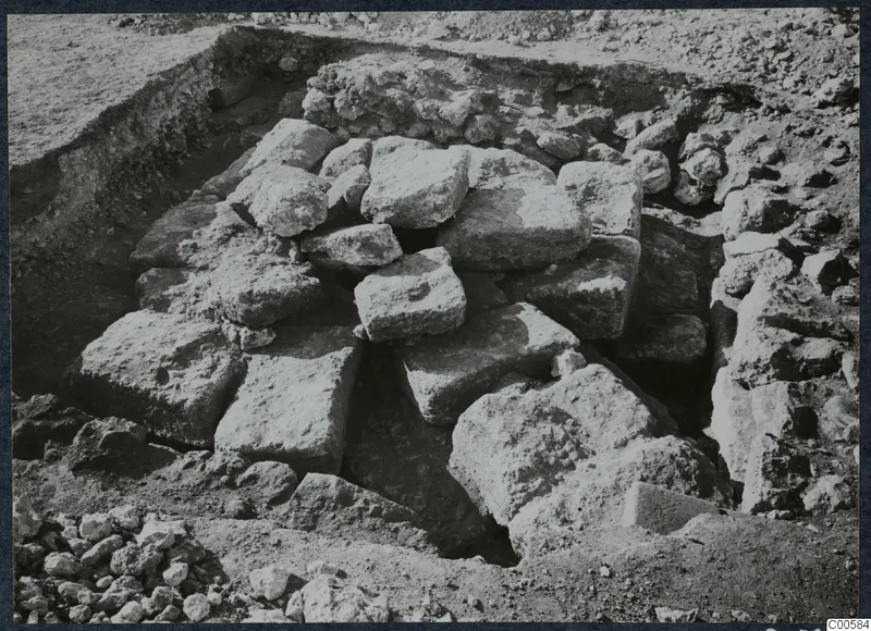 Large squared stone blocks heaped in an excavated pit at Vouni