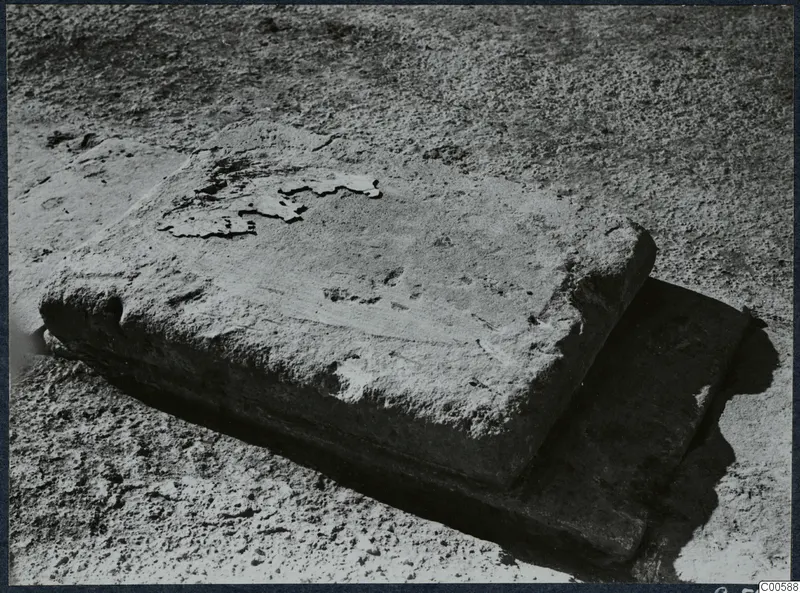 Two rectangular stone blocks lying on dusty ground during excavation at Vouni