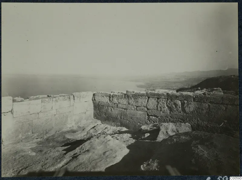 Ashlar walls of the Vouni palace on a rocky height, with the sea and coastal plain beyond.