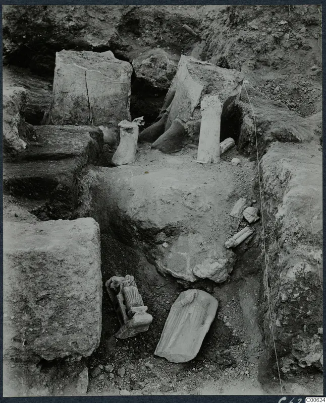 Statues and column drums lying in situ in an excavated room at Vouni