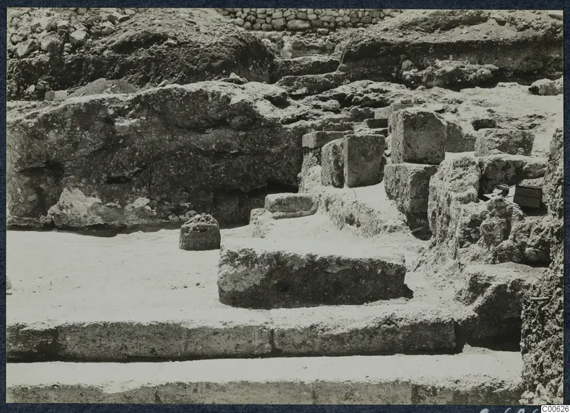 Excavated stone wall, blocks and steps at the palace at Vouni, with no people visible.